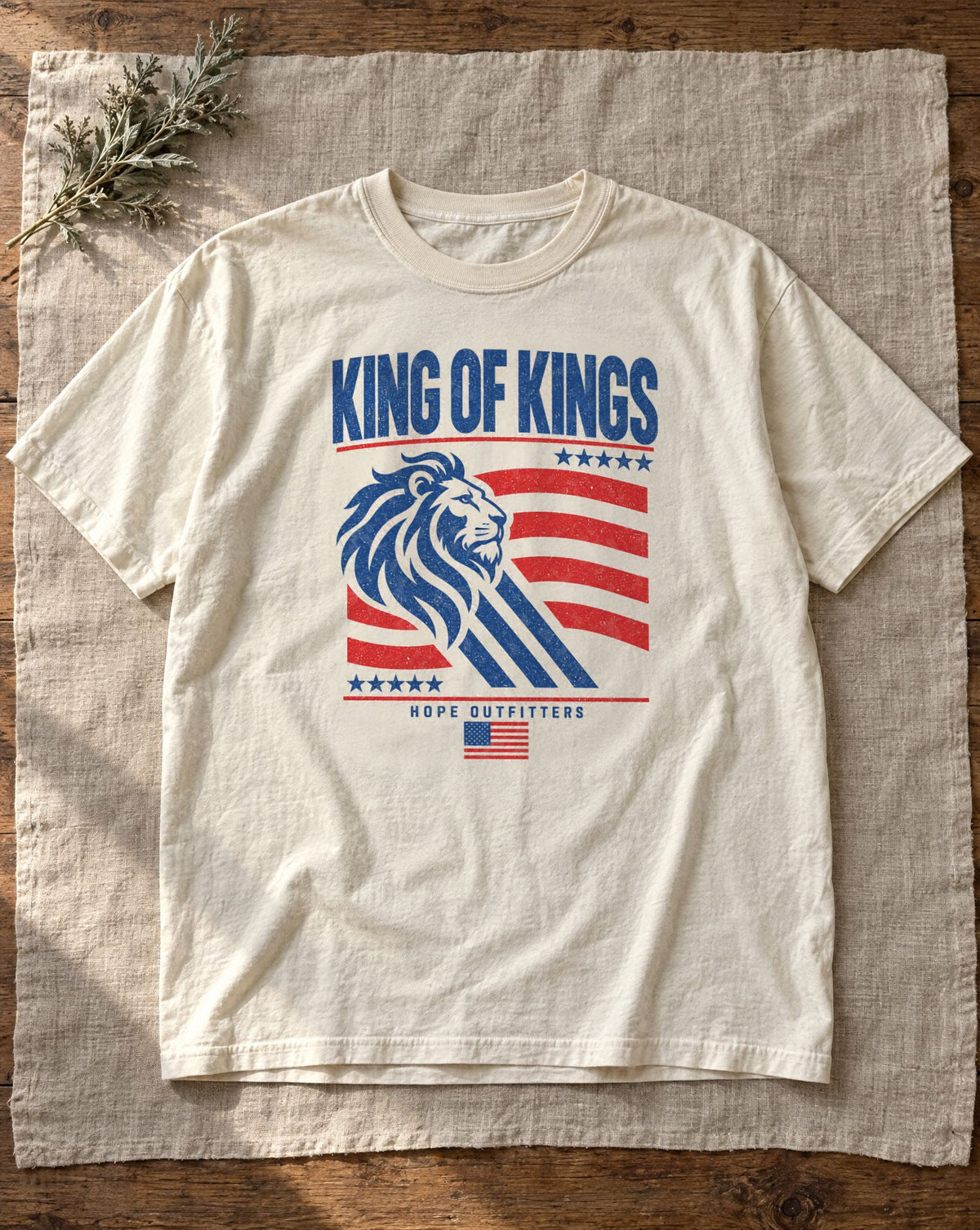 King of Kings Lion Tee - ivory tee flat lay on linen showing the King of Kings lion front print
