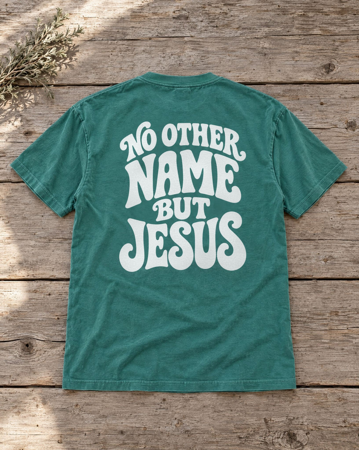 No Other Name But Jesus Tee - emerald tee flat lay showing the No Other Name But Jesus back print