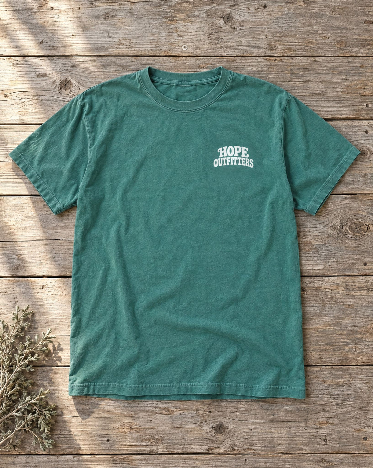 No Other Name But Jesus Tee - emerald tee flat lay showing the Hope Outfitters left-chest front print