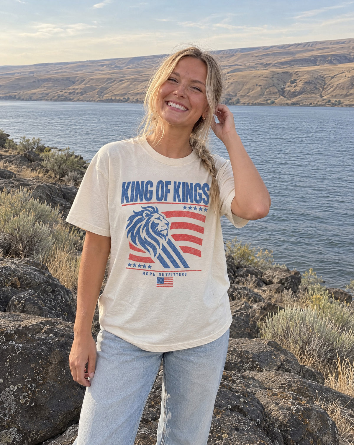King of Kings Lion Tee - blonde woman standing on a basalt boulder by the Columbia River in the ivory tee