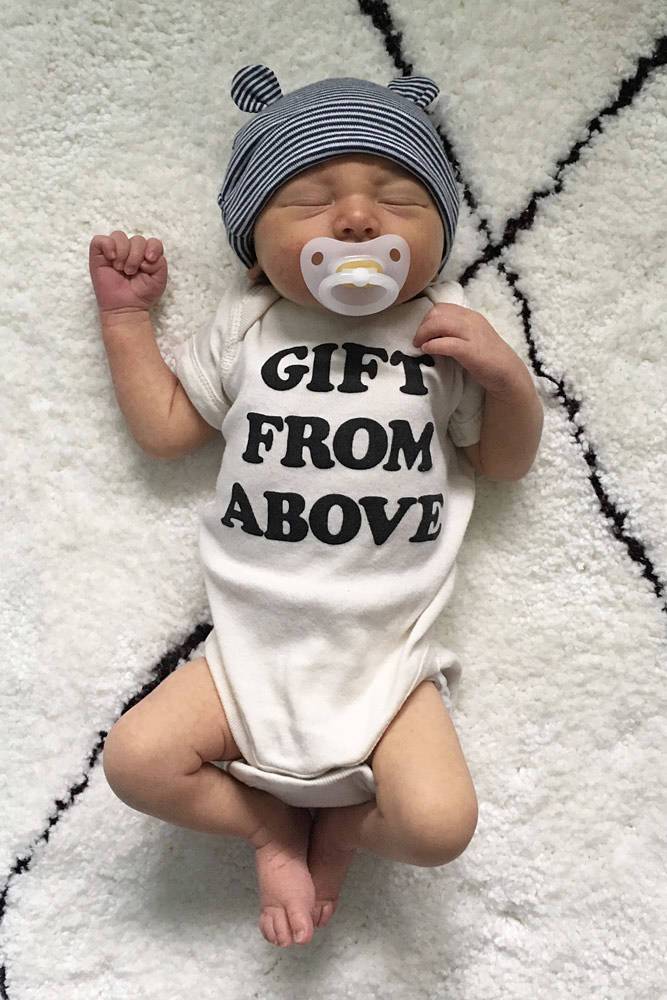 Baby wearing the white Gift From Above onesie